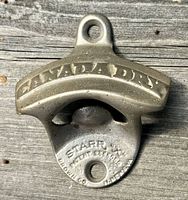 Front view of cast iron Canada Dry wall bottle opener showing embossed branding and Starr X maker marks