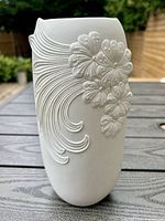 Full view of vase showing embossed floral and cascading linear relief