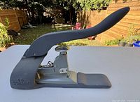 Right-side view of stapler showing extended lever and base