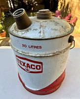 Front view of Texaco 20L oil can showing logo, capacity marking, spout and cap