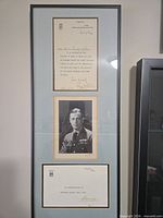 Full view of framed display showing letter, photograph and commemorative card