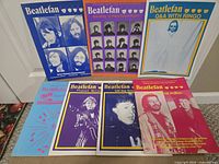 Seven Beatlefan magazines arranged showing all covers