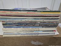 Side view of stacked automotive magazines showing spine dates and titles