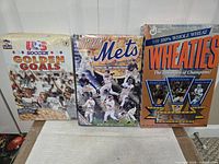 Front view of Golden Goals, Amazin’ Mets and Wheaties boxes