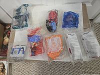 Eight sealed promotional toy and fitness items displayed on surface