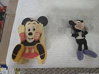 Both Mickey Mouse toys side by side