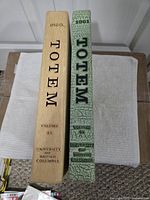 Spines of both Totem yearbooks showing titles, volumes and years
