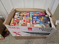 Closed Xerox paper box filled with stacked TV Guide magazines