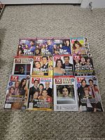 Twelve magazines laid out in three rows showing Star Trek, Women of O.C., Seinfeld, Battlestar Galactica, Star Wars