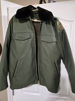 Front view showing color, pockets, collar, size, and zipper