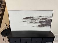 Front view of framed print on console table