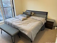 Full view of king bed with frame, headboard, mattress