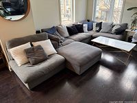 Full sectional setup with ottoman and coffee table for scale