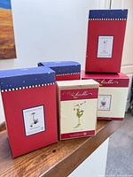 Five boxed Christmas Krinkles ornaments on railing