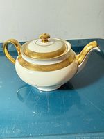 Side view showing gold band, handle and spout