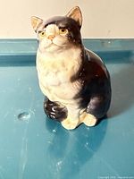 Front view of Royal Doulton cat figurine showing colour and pose