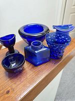 All six cobalt blue glass items grouped together