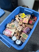 Overall view of stamps, embossing powders, ink pads inside blue bin