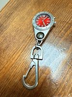 Full view of Fossil keychain watch with compass and carabiner clip