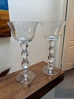 Front view of both clear glass candle holders