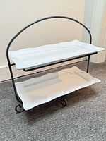 Iron two-tier stand assembled with ceramic platters inserted