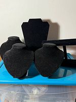 Group of black velvet necklace busts, bracelet bar and display board