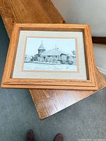 Full view of framed drawing on table