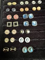 Full tray showing multiple rows of assorted cufflinks