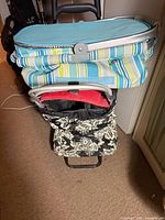 Top view of striped cooler basket stacked on buggy and partial view of buggy fabric