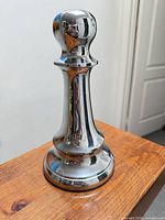 Front view of polished metal pawn