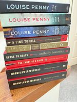 Stack of all nine books showing spines and titles