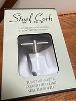 Front of boxed Steel Cork wine stopper showing product and branding