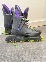 Side view of both skates showing boots, wheels, and laces