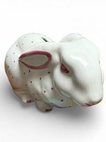 White ceramic rabbit coin bank with pink polka dots