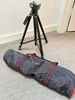 Tripod fully extended beside carry bag