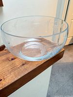 Full view of clear crystal bowl on wooden ledge