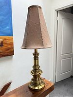 Full lamp with shade on wood surface