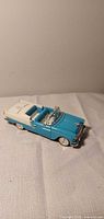 Front-left view of blue and white 1955 Chevy Bel Air die-cast model