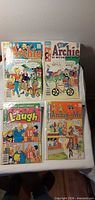 Four Archie comic books laid out showing full covers