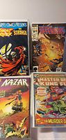 Four bagged Marvel comic books displayed: Marvel Comics Presents (Ghost Rider & Doctor Strange), The New Defenders #150, Ka-Zar, Master of Kung Fu