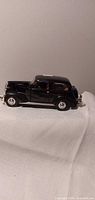 Full side view of black 1937 Chevrolet model car