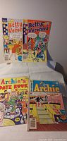 Group shot of four Archie-series comic books: two Betty and Veronica, Archie's Date Book, Archie No.256