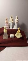 All six Avon figurine bottles and heart trinket displayed