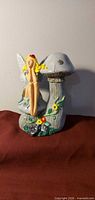 Front view of fairy figurine on mushroom