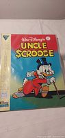 Front cover of Uncle Scrooge comic showing title, artwork and Gladstone logo