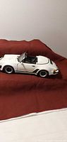 Left side view of white Porsche 911 Carrera model