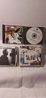 Group shot of five CDs including Elton John, Joe Cocker, Beatles disc displayed