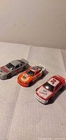 Three die-cast NASCAR cars in full view