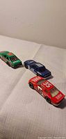 Three die-cast NASCAR cars grouped on tabletop