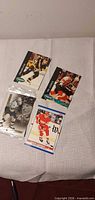 Group shot of four NHL hockey trading cards displayed on table